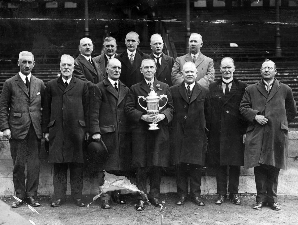 The directors of Airdrieonians Football Club stand proudly with the Scottish Cup at Ibrox Park, Glasgow. (1924)