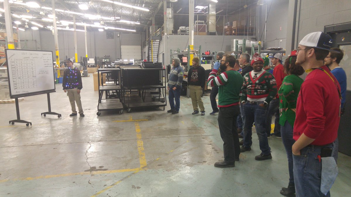 SyneticTech's tweet photo. Synetic employees participating in an Ugly Christmas Sweater Contest as operations wind down for the #HappyHolidays https://t.co/rDWmXIrTke