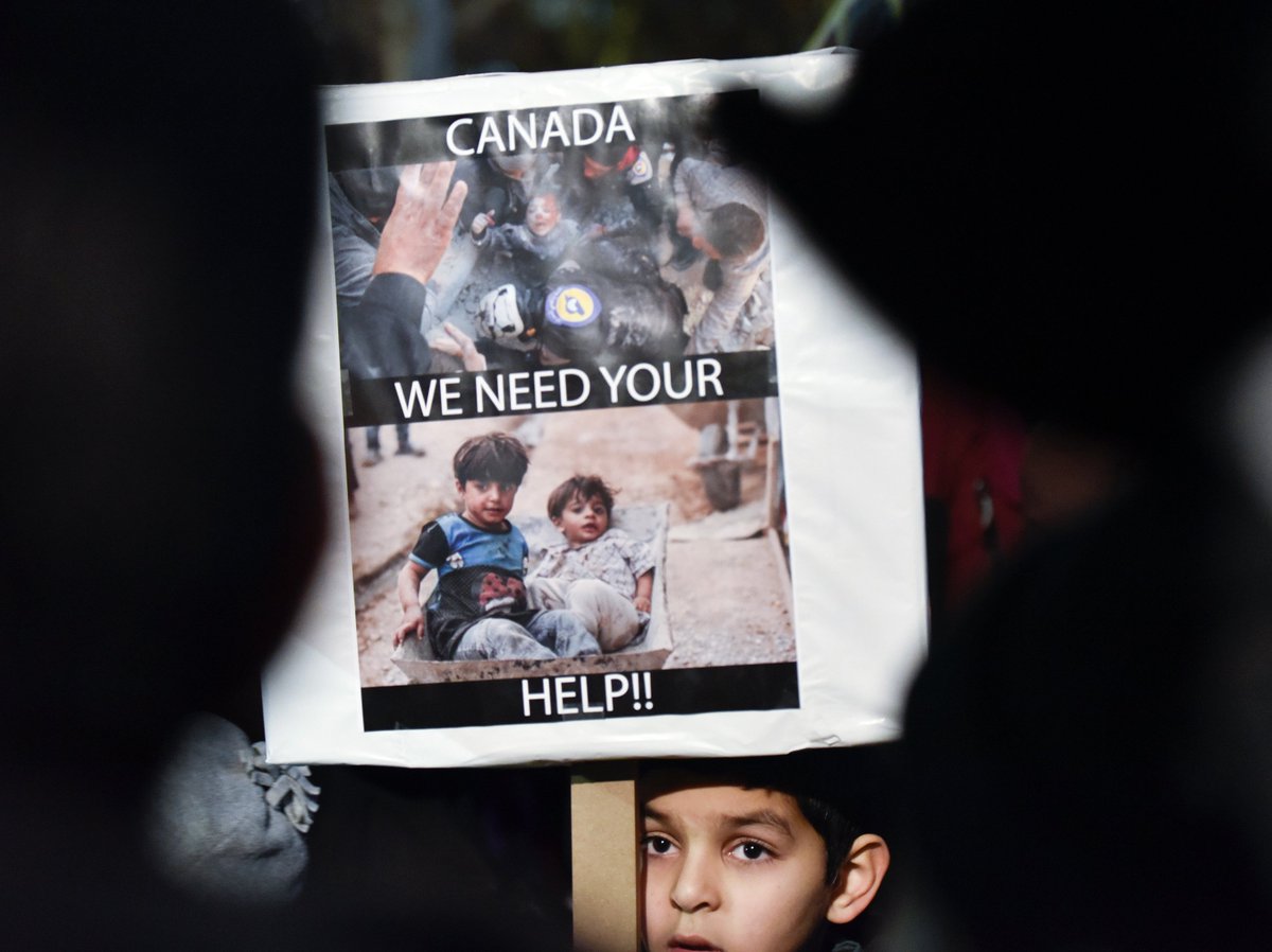 JLRenn's tweet photo. A boy holds a sign in the 200 protesters calling for action on Aleppo, Syria at a rally of solidarity at #HamOnt city hall #IStandWithAleppo https://t.co/Z73lhXwgCE