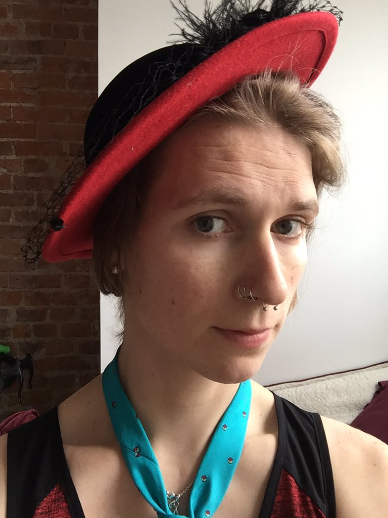 Emma with a dashing red hat and neck tie
