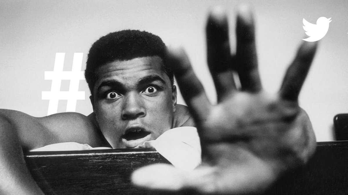 Muhammed Ali reaching for the camera with a hashtag symbol in the background