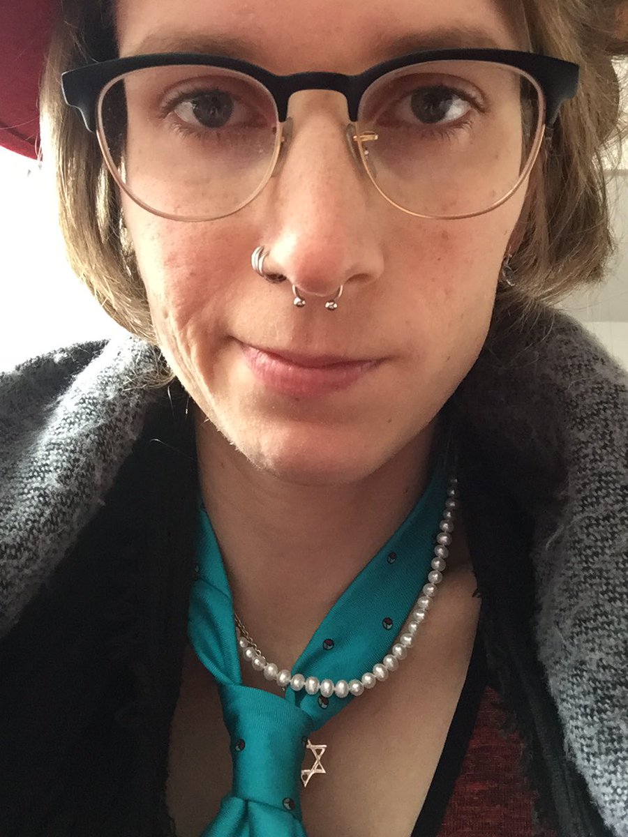 Close up selfie with pearls, necktie, and Star of David all visible
