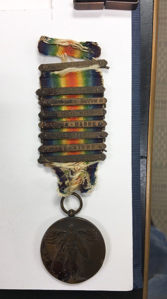 WWI service medal of Joseph Bruccoli in for rehousing. The bars represent the battles he fought in #foundinlibraries