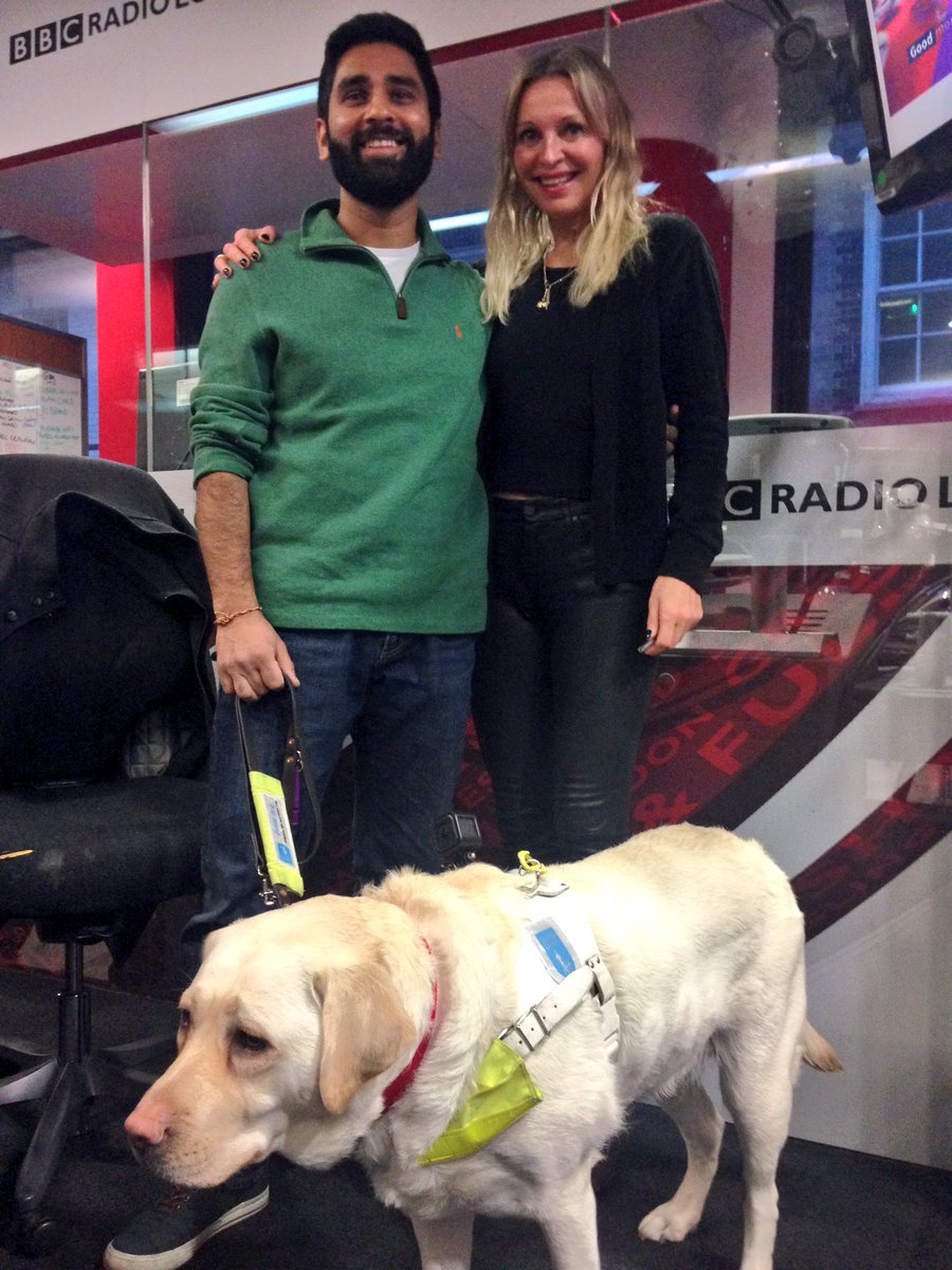 Amit is standing next to BBC London radio presenter Nikki Bedi with Kika
