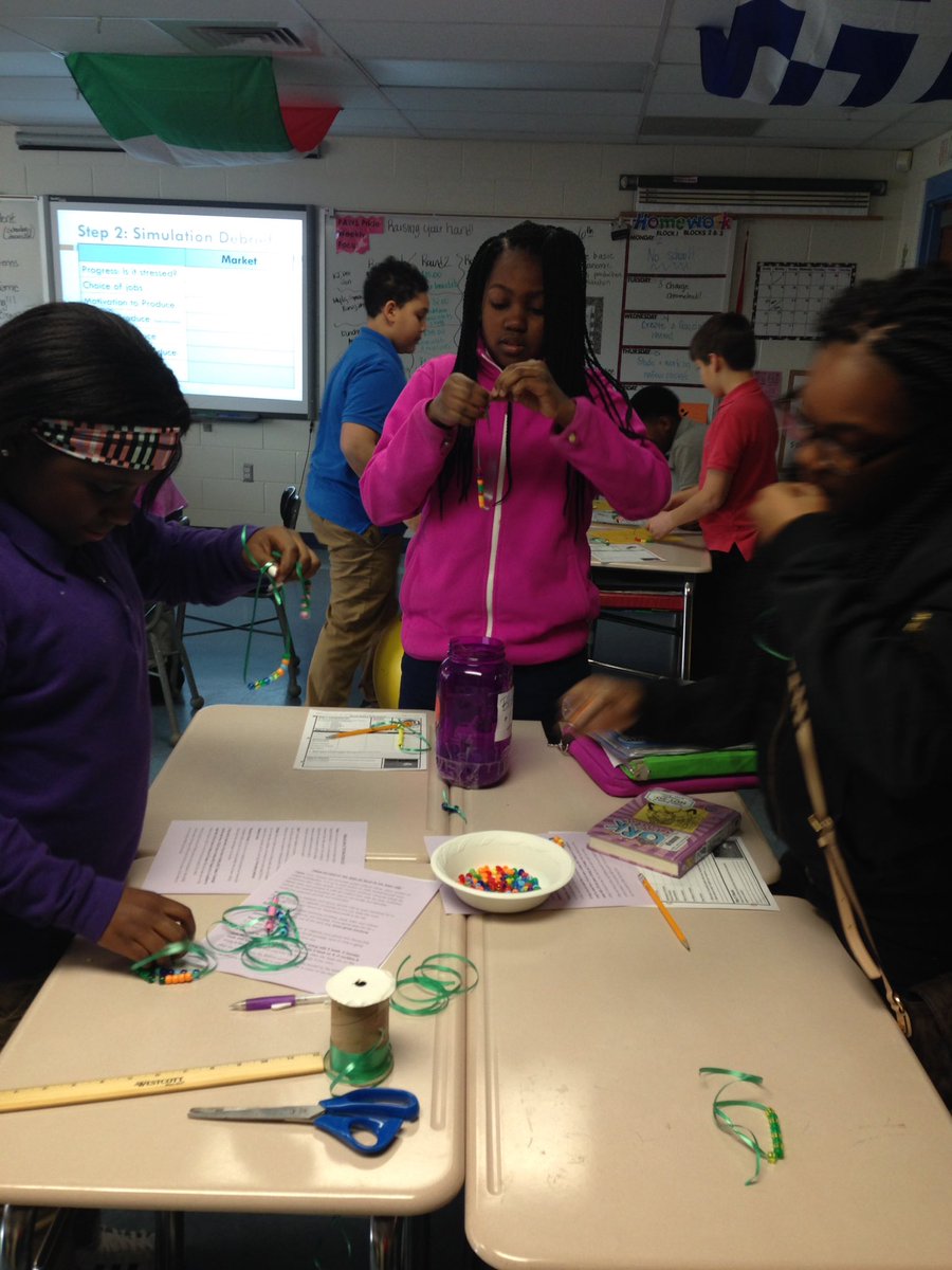 Working on our #economicsystems bead game simulation! #socialstudies #econ #teamwork 🤗 @SkylineJaguars