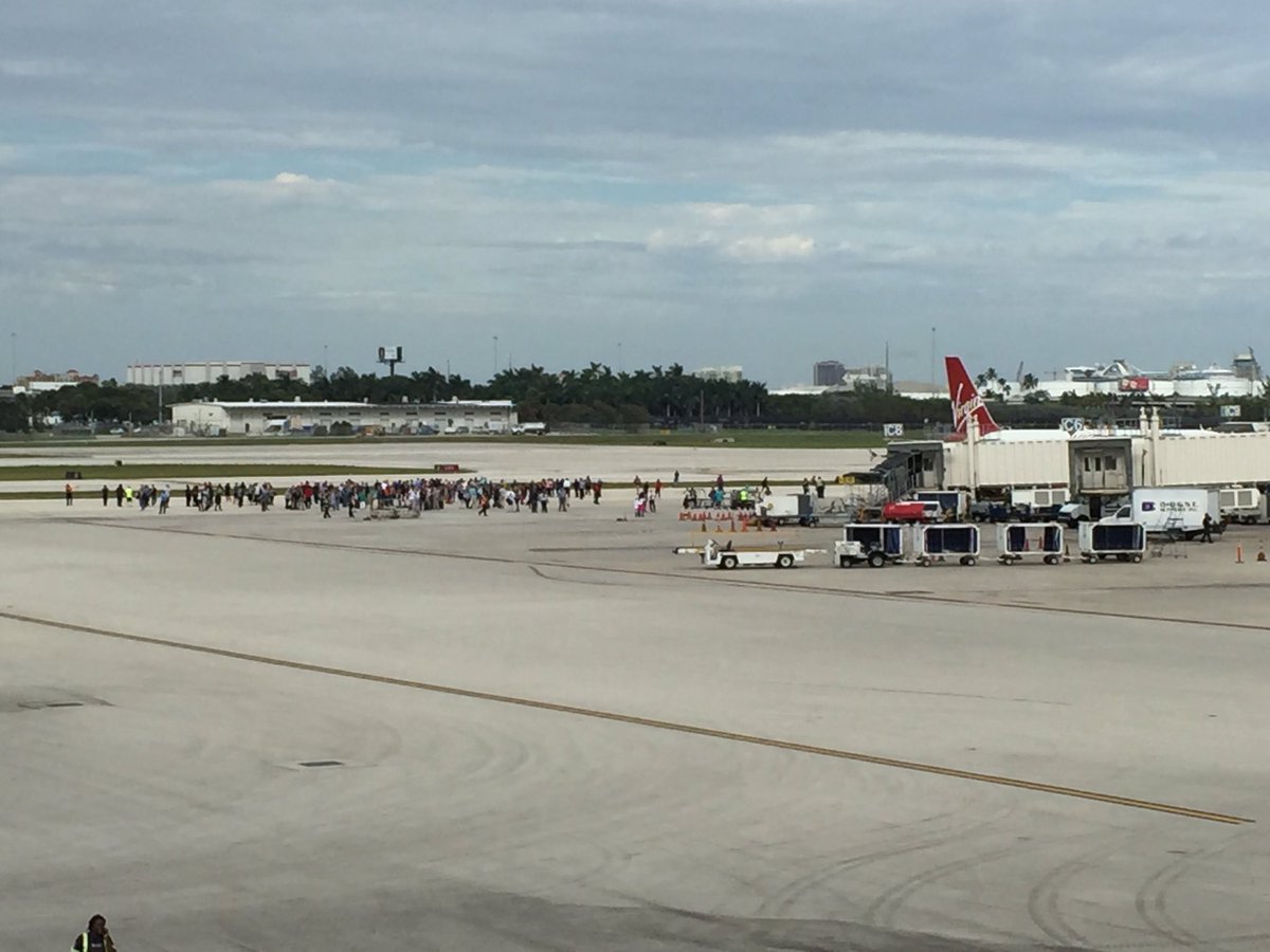 MarissaNBC6's tweet photo. Terminal 1 being evacuated at FLL, alarms going off as people run out. Another incident unfolding inside parking garage at Term 2 @nbc6 https://t.co/YJfUAUkWbK