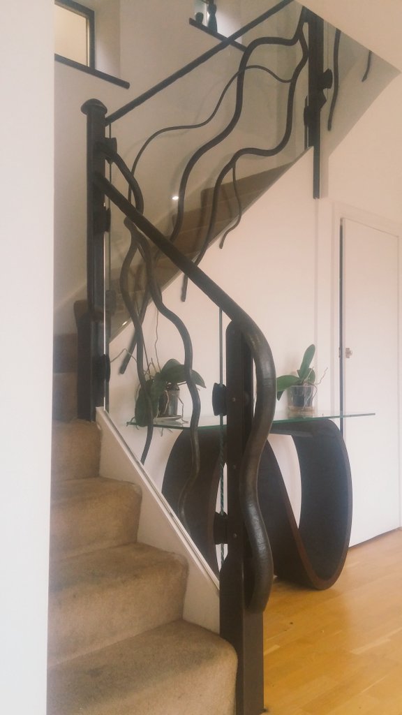 Organic and glass banister. Texture on the metal invites you to run your hand along the surface. Modern iron for a contemporary home London.