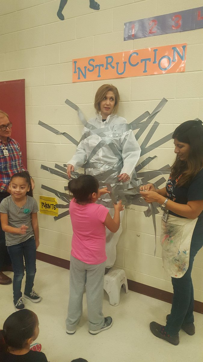 NISDmartin's tweet photo. Ms. Cobarruvias was the proud runner up of the Pasta for Patients campaign. Students duct taped her to the wall. #goodsport #principalduties https://t.co/Sve2nReKwU