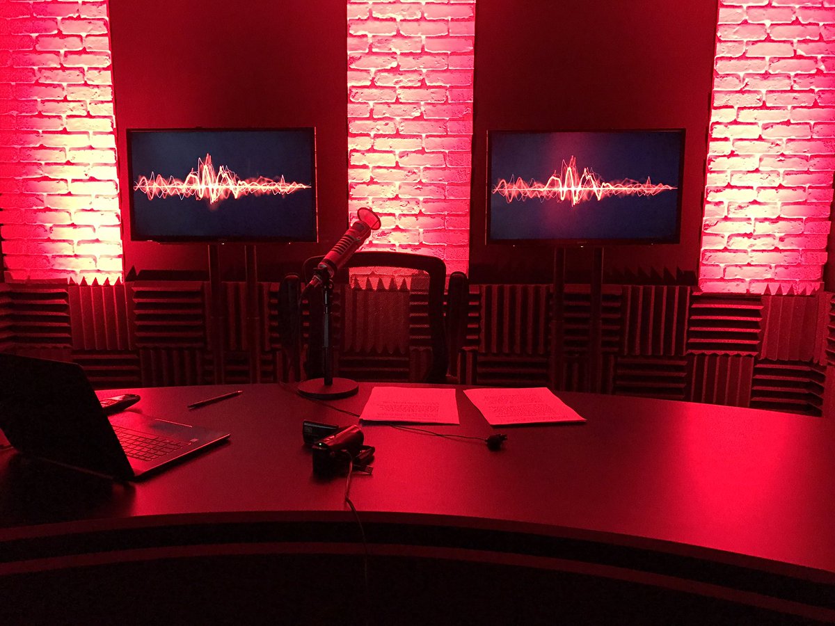 KyleKulinski's tweet image. The Secular Talk studio in red looks a little like a strip club or a brothel.