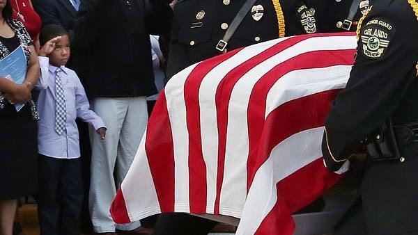 orlandosentinel's tweet photo. A young boy salutes as the flag-draped casket is carried during funeral services for Orlan… https://t.co/jUxQWupkuu https://t.co/NNOSz2paI6