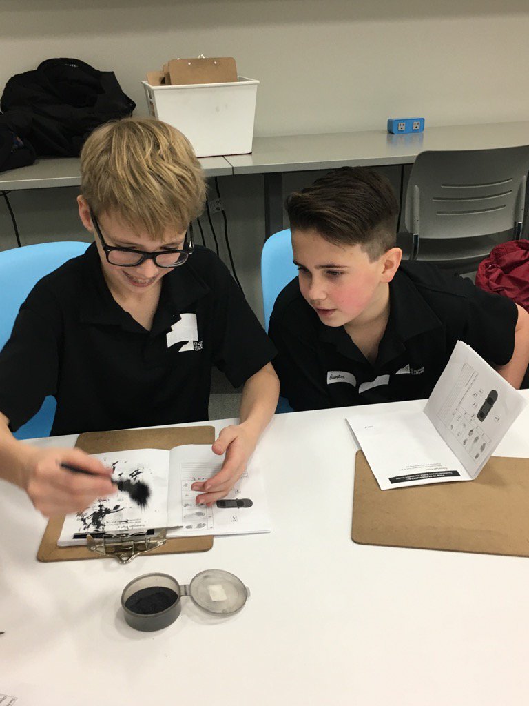 Grade six students using iron filings to dust for finger prints at Youth Link Calgary.
#wearerundle 
#youthlinkyyc