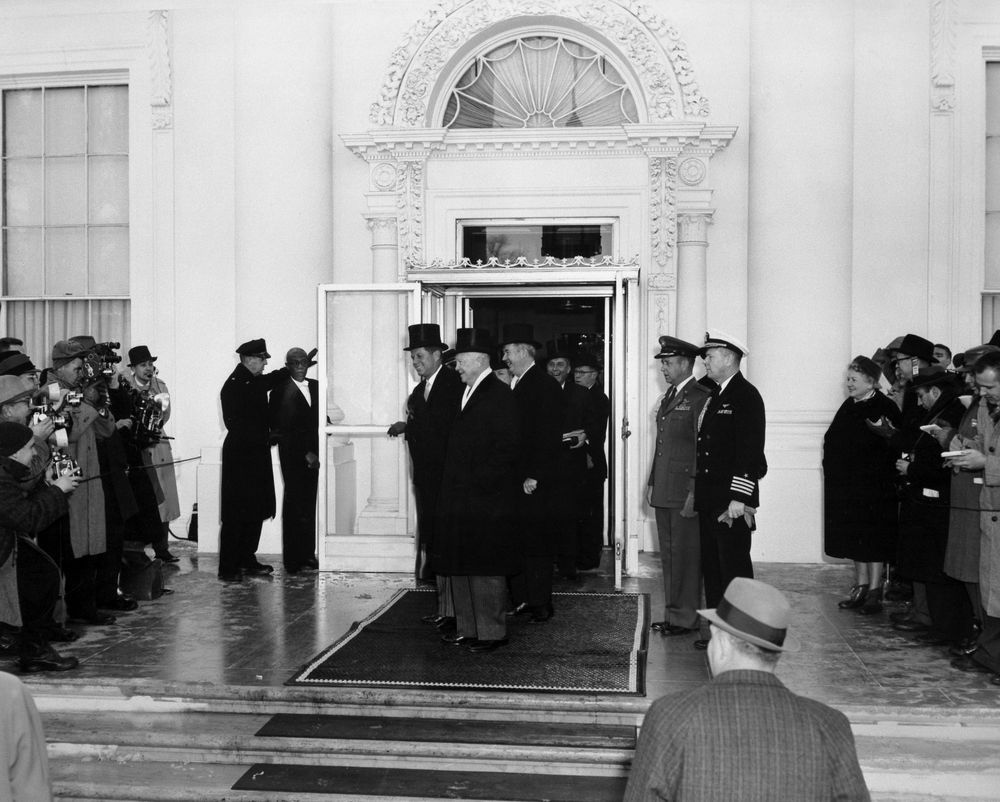 President-Elect Kennedy and President Kennedy greet reporters at the White House on the morning of the Inauguration, January 20, 1960