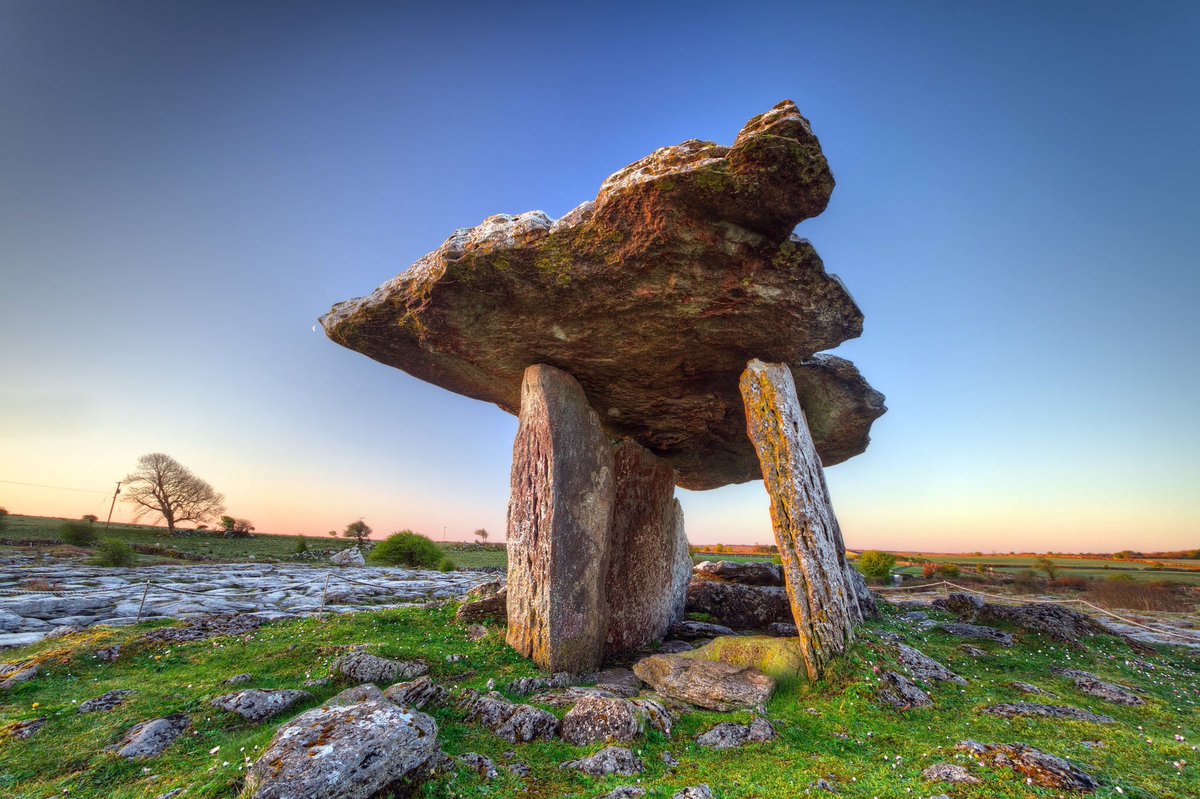 Poulnabrone dolmen (Poll na mBrón in Irish, meaning 'hole of the quern stones') is a portal tomb dating back to Neolithic era, 4200-2900 BC.