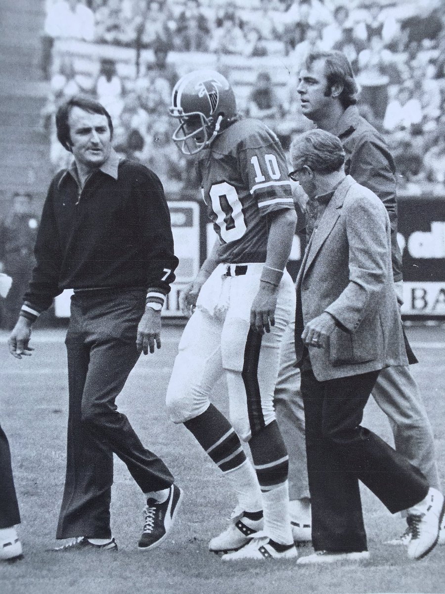 BPetersenWSB's tweet photo. Falcons fan's Dad is former team doctor Charlie Harrison, tall guy walking behind Steve Bartkowski in this pic.  6pm https://t.co/LpIEXLnutN