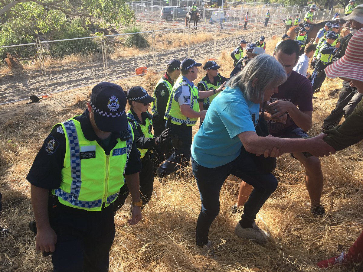 eljimberino's tweet photo. Police used by @LiberalAus to threaten arrest at #Roe8 toll rd. Bulldozing within 20m of tree sitter yesterday. #justanotherdayinWA #noroe8 https://t.co/ds31Af7TrL