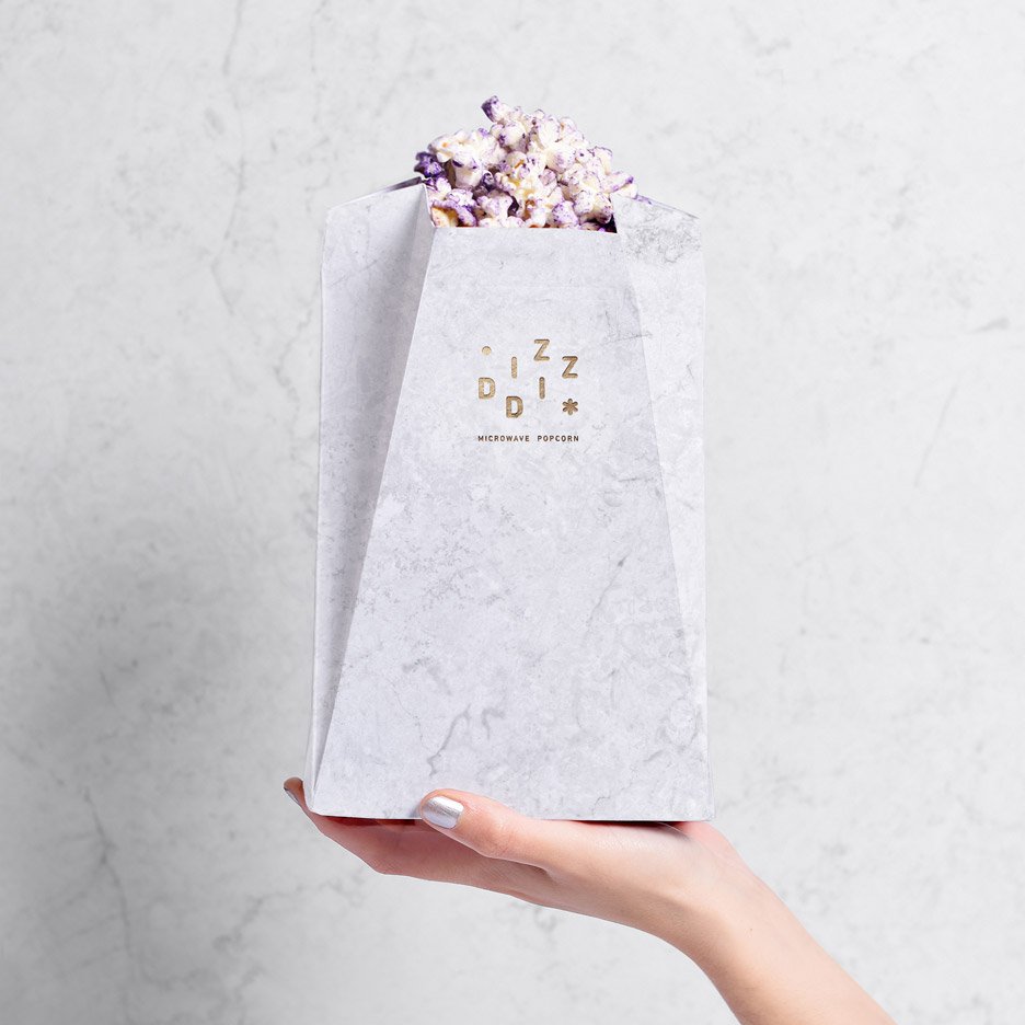 dezeen's tweet photo. Tatabi Studio designs marbled packaging for Diz-Diz microwave popcorn: https://t.co/jvrRYUUMJ5 #nationalpopcornday https://t.co/H10WopSTP4