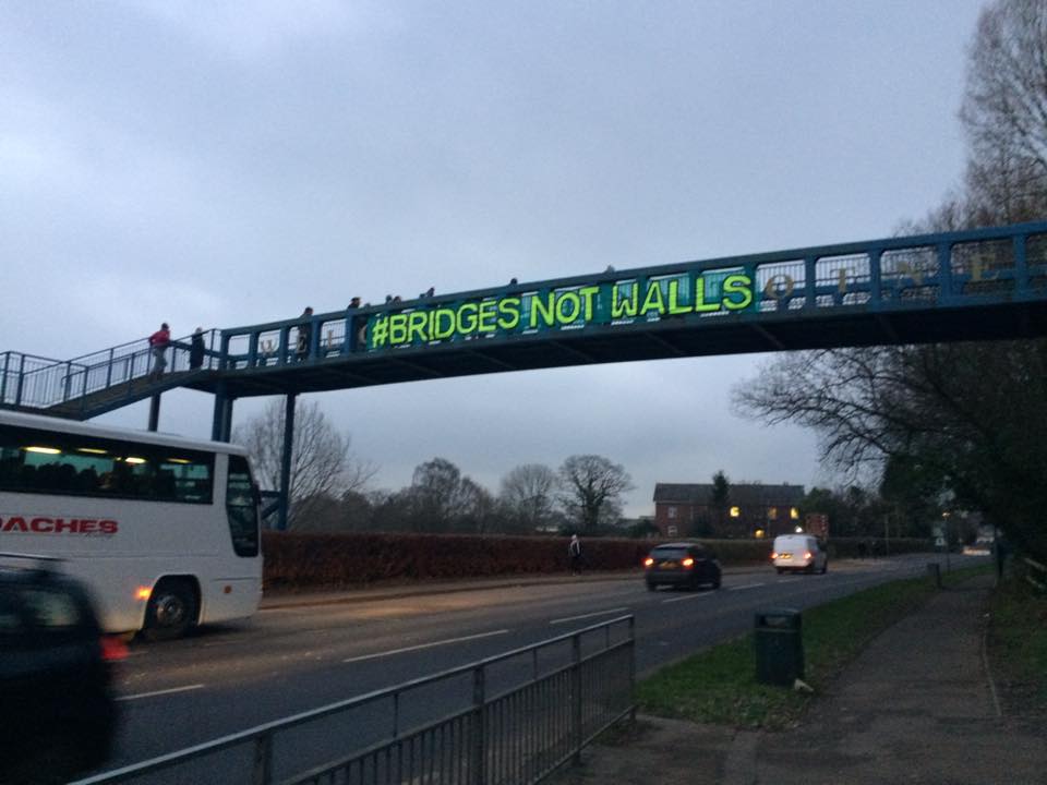 robintransition's tweet photo. Totnes this morning #bridgenotwalls. In solidarity with our brothers and sisters around the world. #Trump #Inauguration https://t.co/tvq1ji473h