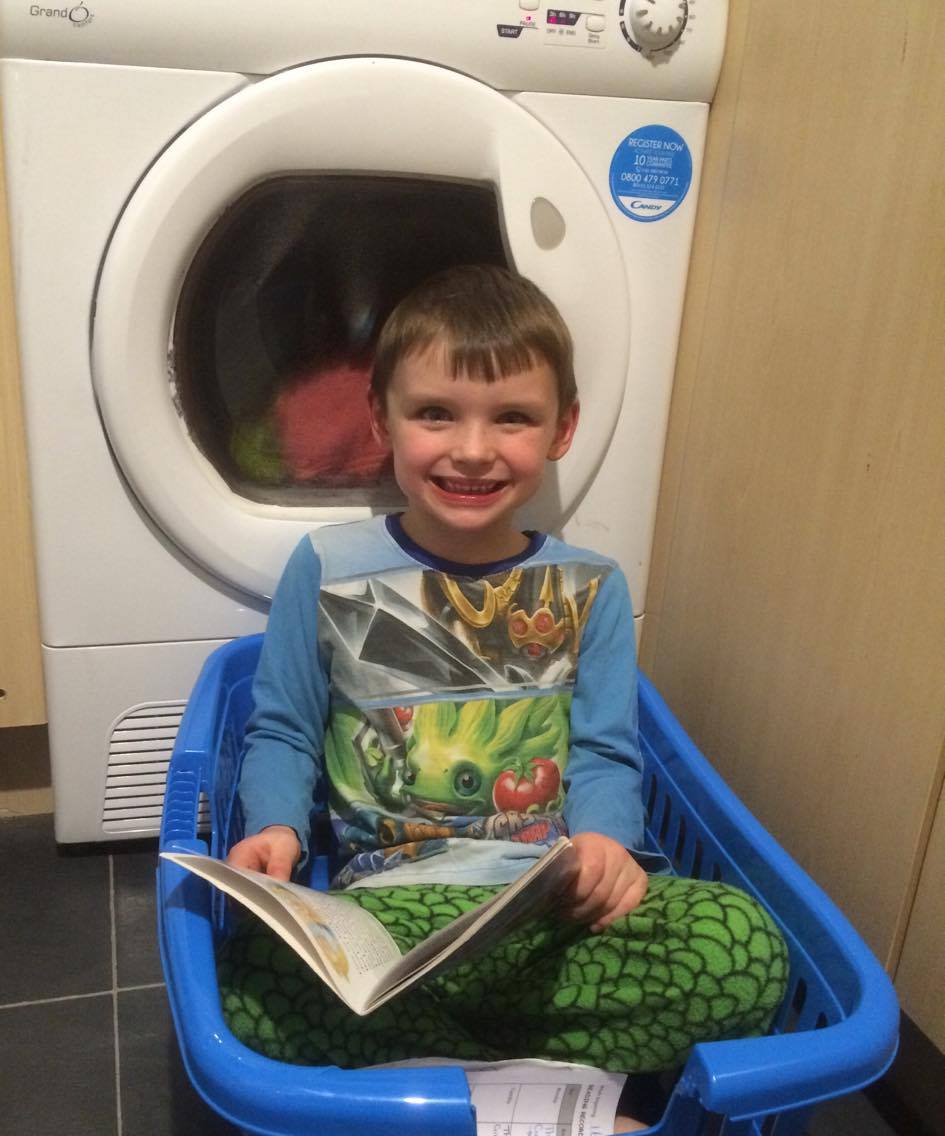 FionaMrsgreen's tweet photo. Just found Harry reading in the wash basket! Good photo opportunity for 'reading in an unusual place' 😀📗@AncasterPrimary  #ReadingChallenge https://t.co/uYWSwY6WVo