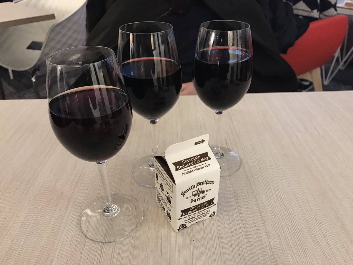 three full wine glasses and a chocolate milk