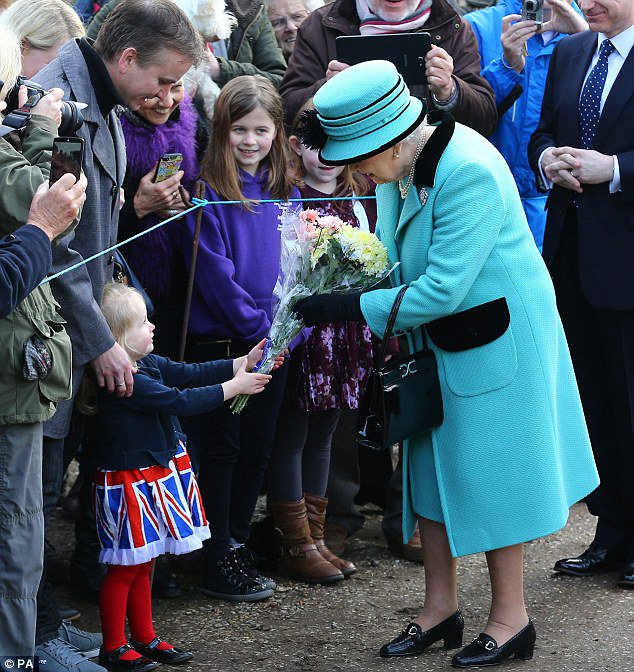 The Queen looks elegant in pale blue as she greets young well wishers at a church service dailym.ai/2jOXvmY