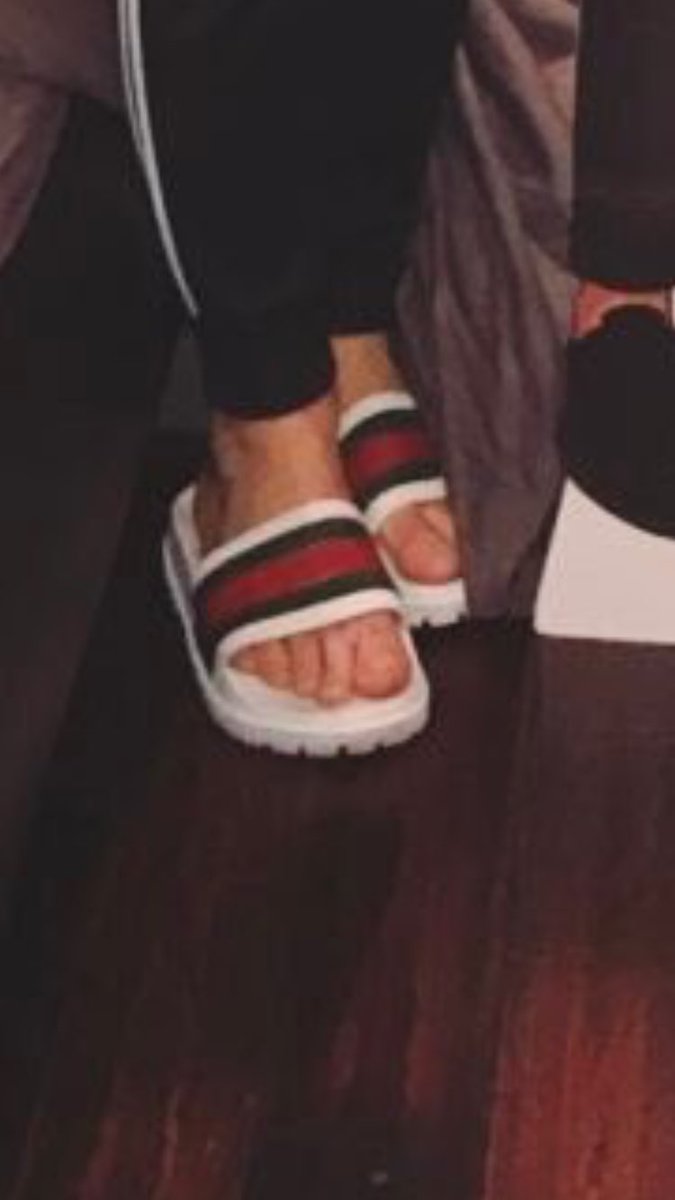 white gucci slides on feet