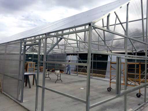 SantoHighSchool's tweet photo. Greenhouse roofing panels are on and side walls going up today. Woo-hoo! https://t.co/IyYSnohvRp
