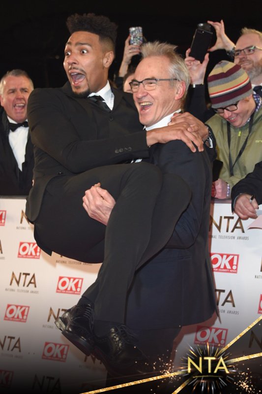 OfficialNTAs's tweet photo. Larry Lamb and Jordan Banjo playing about on the red carpet #NTAs #NTA2017 https://t.co/ShCkfZQEtD