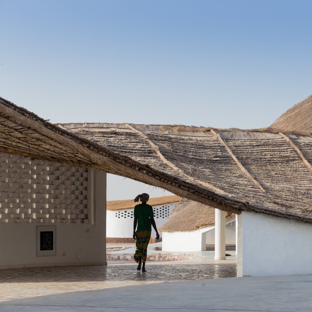 dezeen's tweet photo. Toshiko Mori uses compressed earth and bamboo for cultural hub in remote Senegalese village: https://t.co/nGqsmfnWOT https://t.co/VE6nbjBk7c