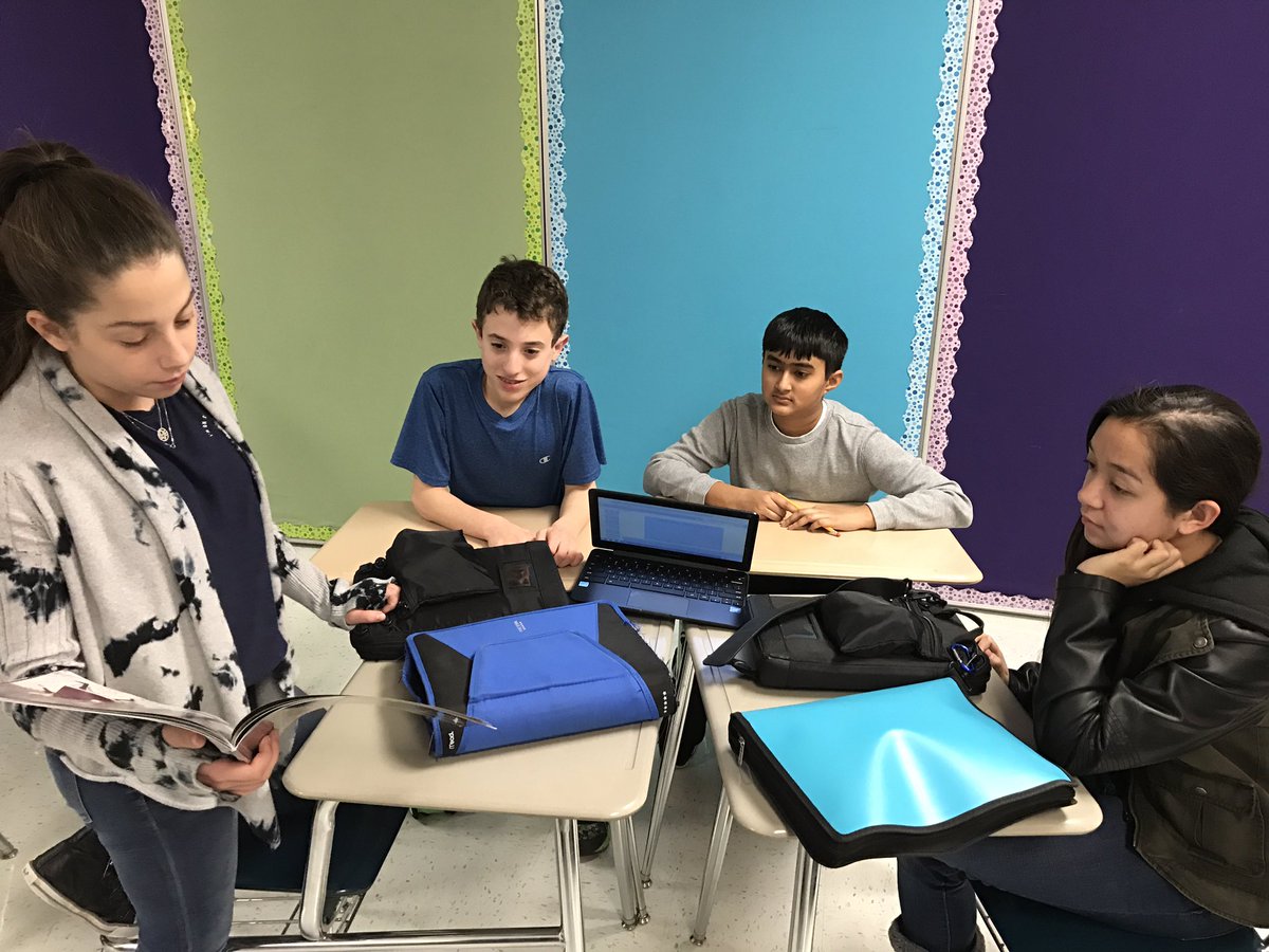 Students reading children's books to one another as they begin their study of Holocaust literature. #engage109 <a href="/109Caruso/">Caruso Middle School</a>