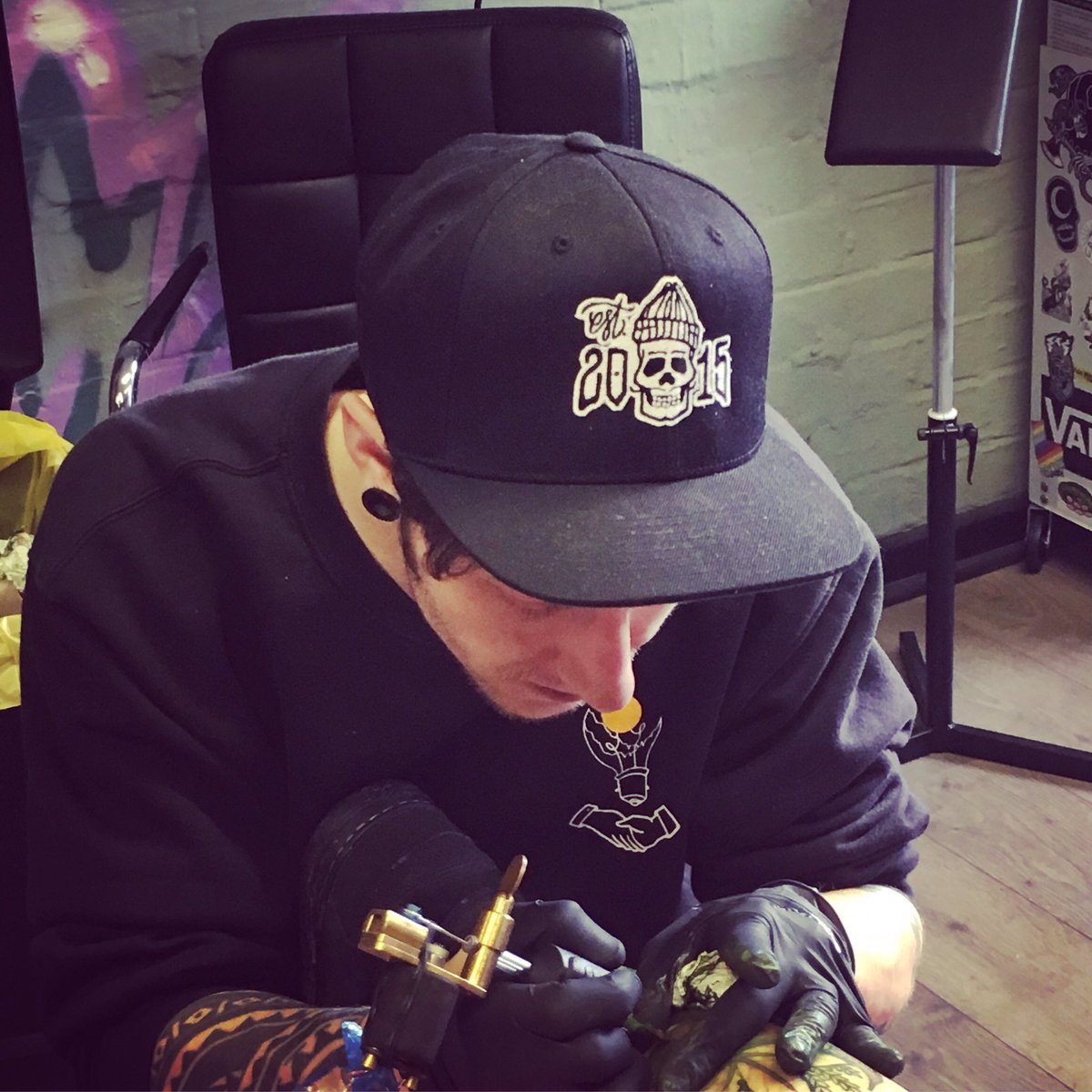 influentialCB's tweet photo. Ryan hard at work sporting the new skulli cap! #streetwear #urban #tattoo #graffiti #snapback #skull #skateboard #hiphop #grime #brand https://t.co/isjGNP4N80