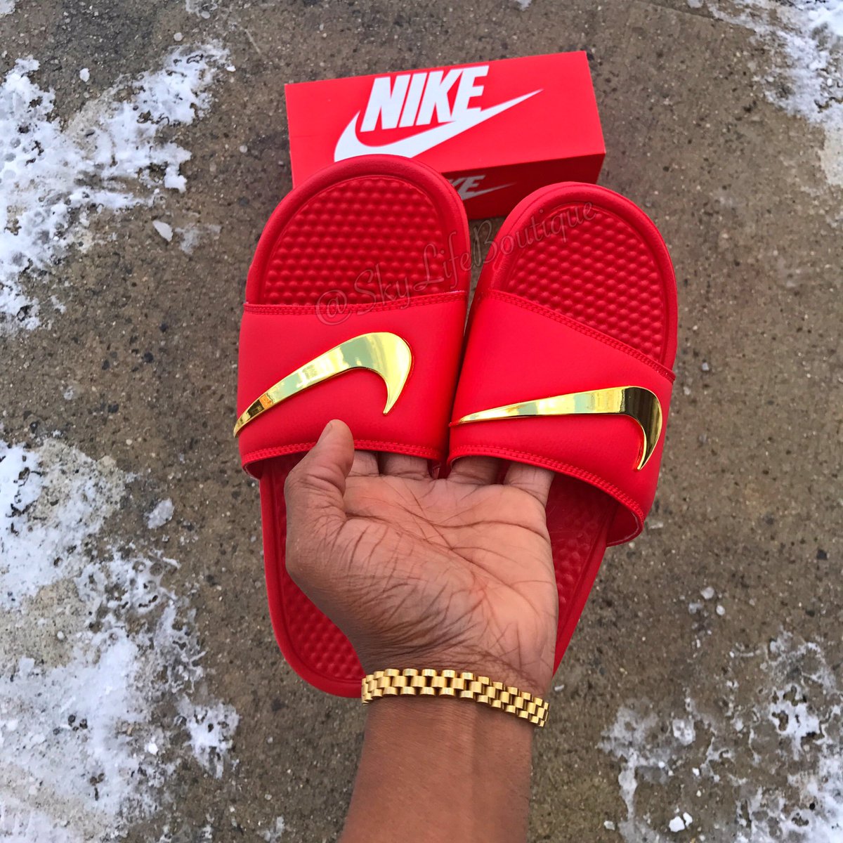 maroon nike slides with gold nike sign
