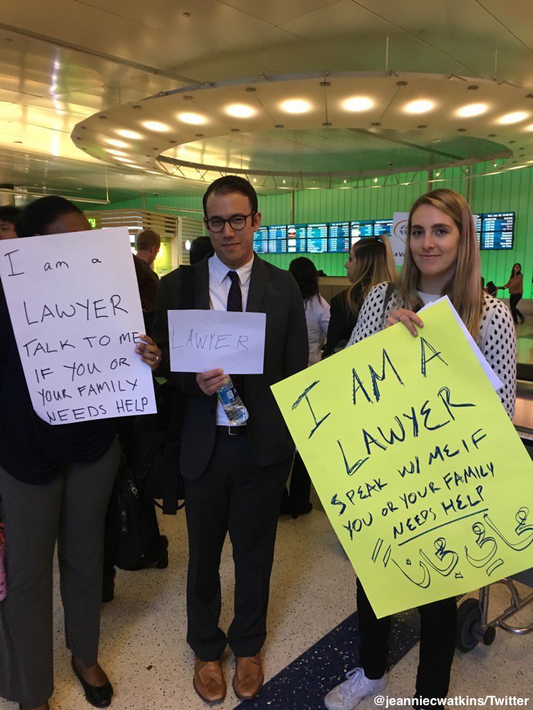 ABCPolitics's tweet photo. "Here to help": Lawyers hold signs at airports from DC to Los Angeles offering assistance to detained passengers https://t.co/19batwz8Ci https://t.co/eAD5ZKbcNL