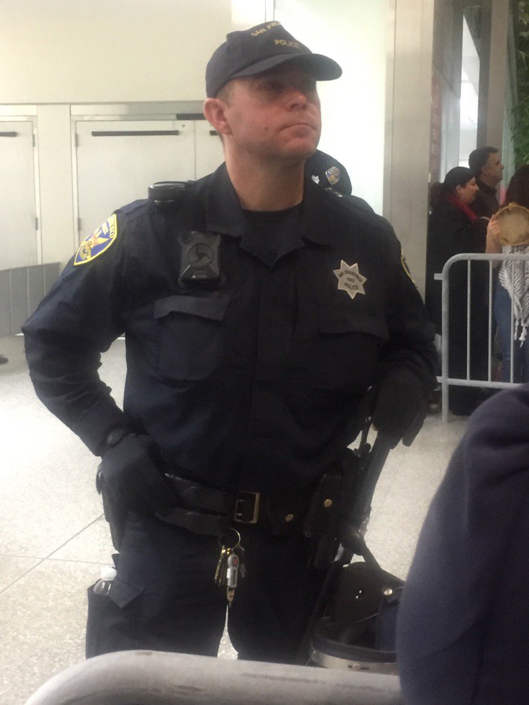 awinston's tweet photo. From SFO demo: SFPD cop w/covered nametag. Self-id'd as Ofc O'Keefe when asked, but still in violation of CA law https://t.co/z5zCwQfiH8