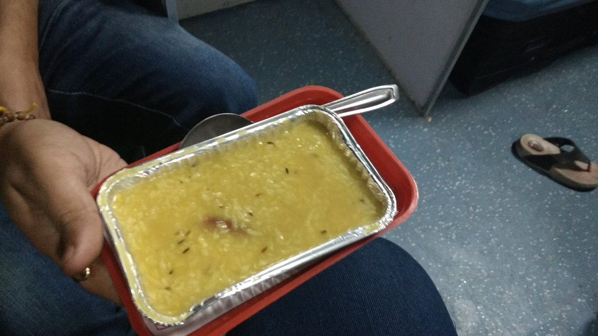 ajxhere's tweet photo. @sureshpprabhu @RailMinIndia Sirs, we just got probably puja prasad in the form of Khichdi served to us for dinner. 😂 #premiumtrain https://t.co/3YbbPTBShD