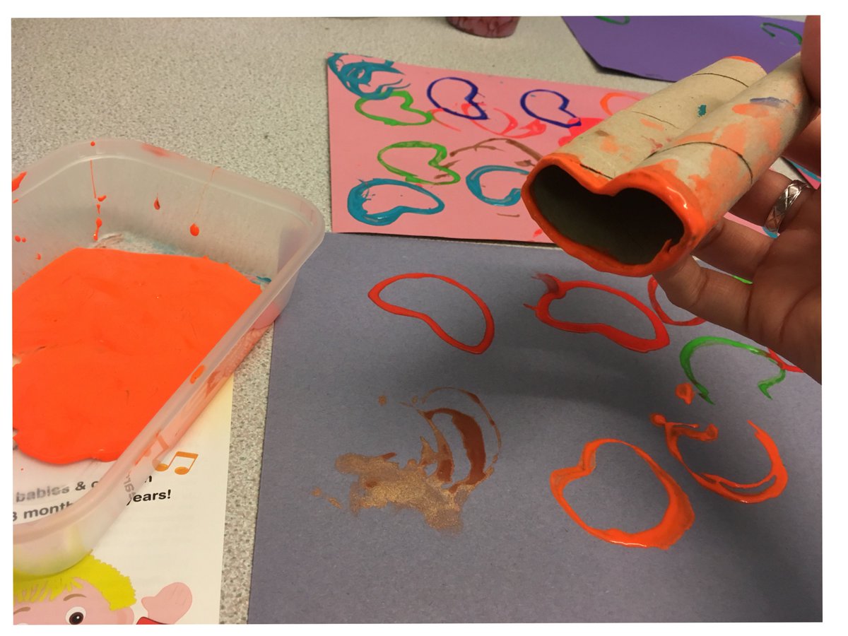 Painting hearts with squashed kitchen rolls for the God loves us theme at Caterpillars carers’ and tots’ group today