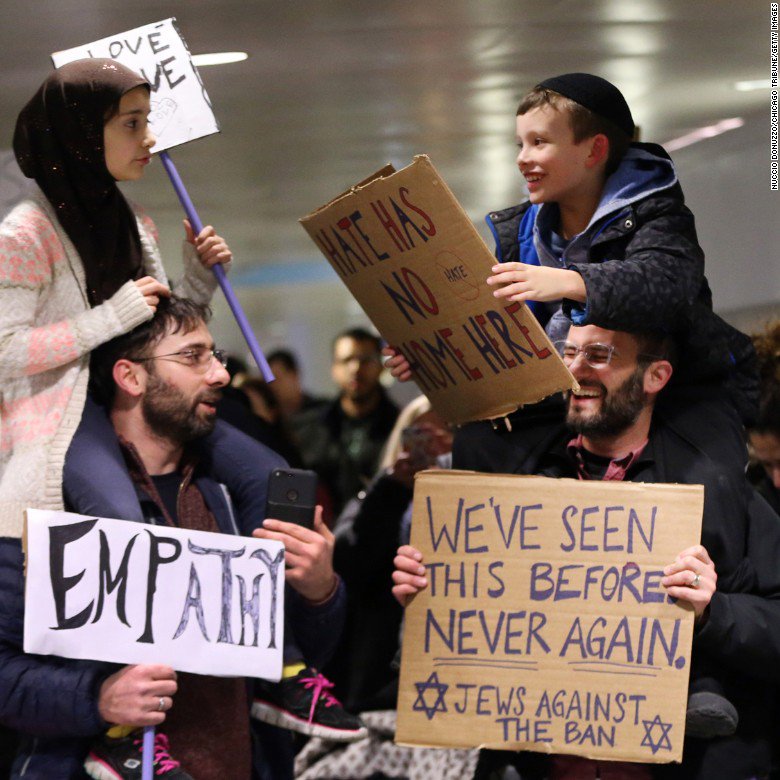 CNN's tweet photo. This photo of a Muslim girl and Jewish boy rallying for the same cause with their dads has warmed the hearts of many https://t.co/PON6ML0OkO https://t.co/nW4Dme5673