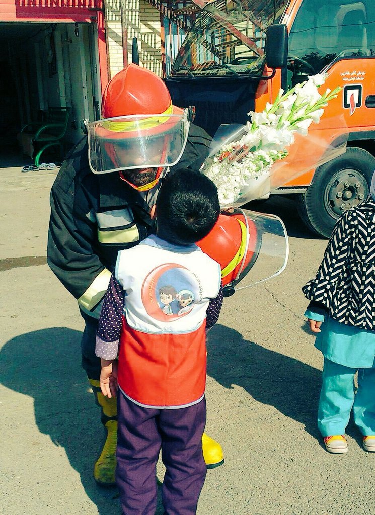 Seddighi_Hamed's tweet photo. Empathy of a child member with a #fireman in #Yazd after #plascobuilding disaster, #IranRedCrescent,@IFRC_MENA https://t.co/BfVWB41OfA