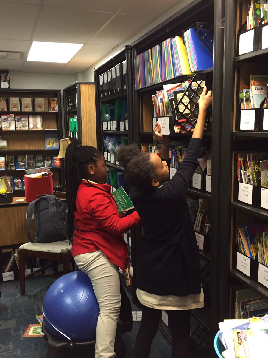 5th grade student volunteers sorting iPick books in the Book Room for K-4 students. @gailandjoan