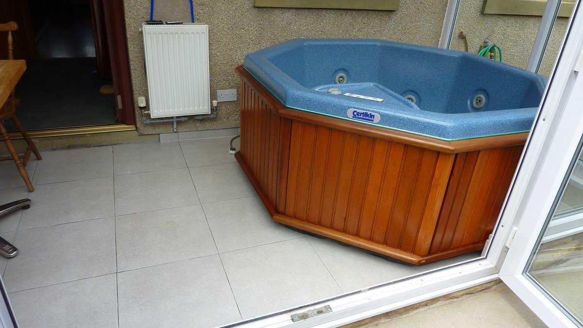 Conservatory floor tiled prior to delivery of new hot tub.