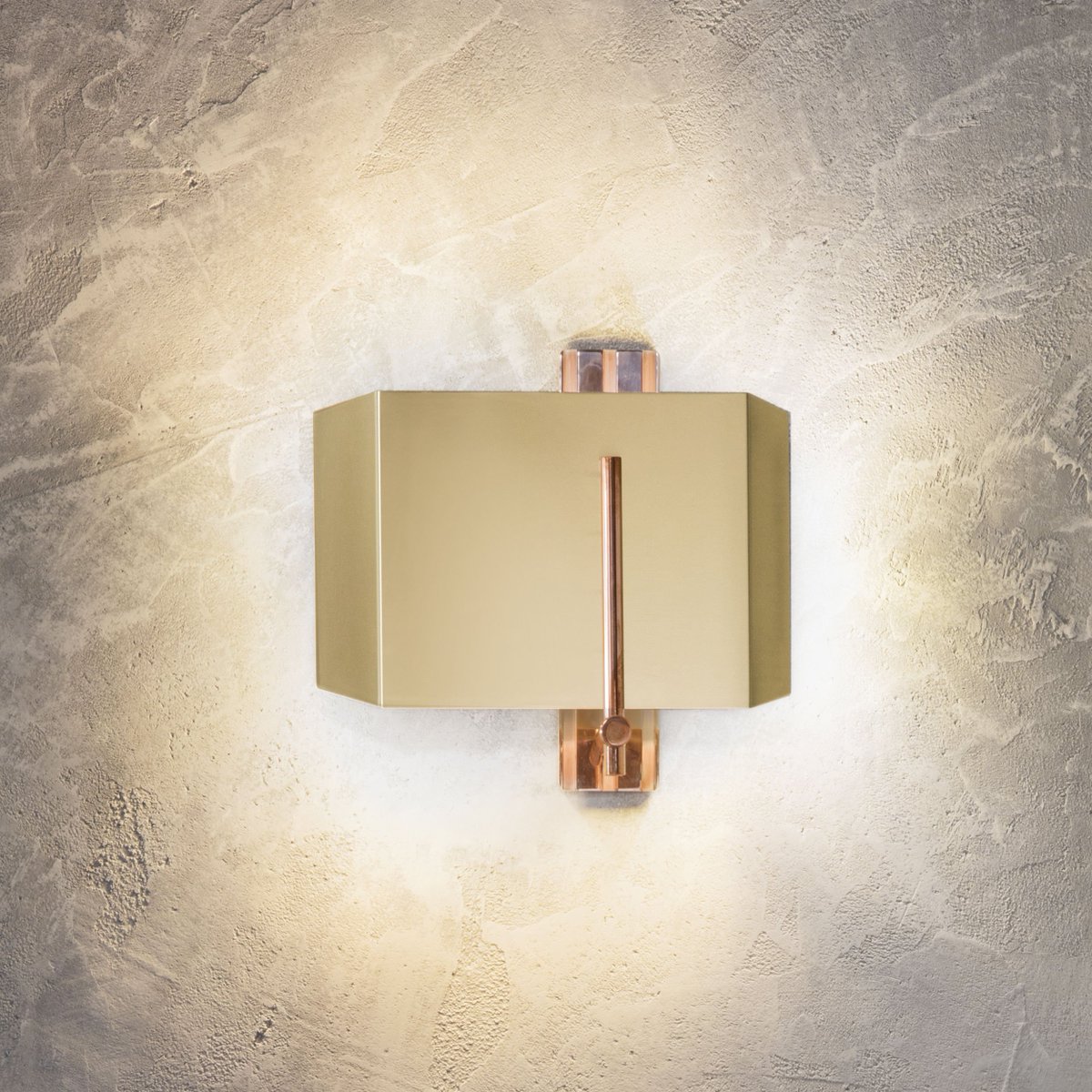 The dazzling Aegis wall light in brass and copper creating an ambient glow. A perfect statement light.