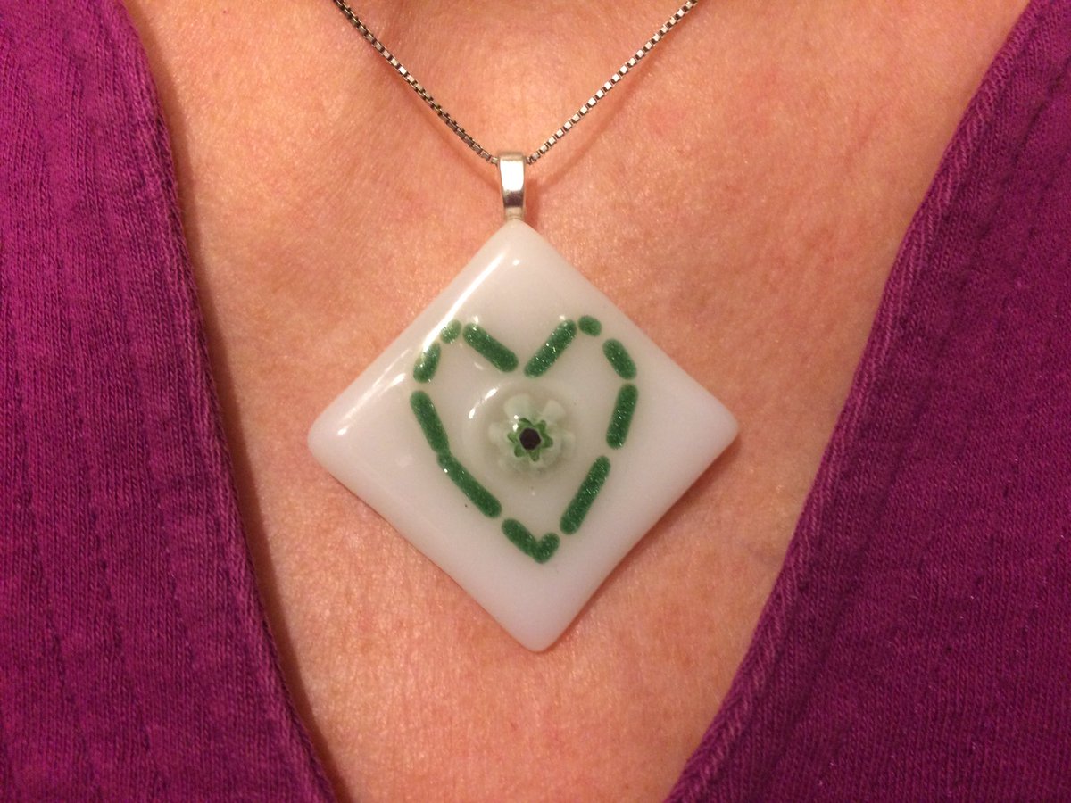 HelenEPye's tweet photo. My contribution to the #showthelove campaign! A green heart fused glass pendant - fresh from the kiln! Love the 2017 crafts @NewcastleEastWI https://t.co/jW3TMfSQGj