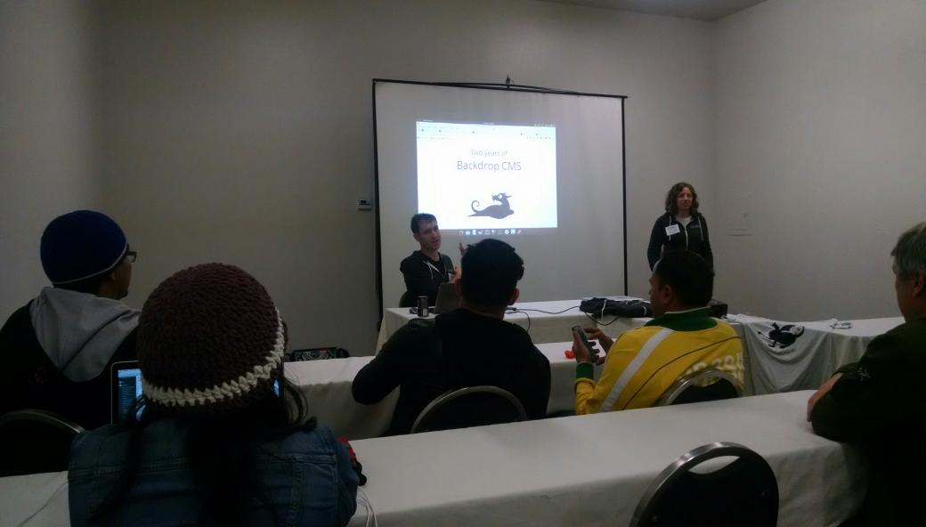 Jen and Nate from Backdrop giving a presentation to a room full of people
