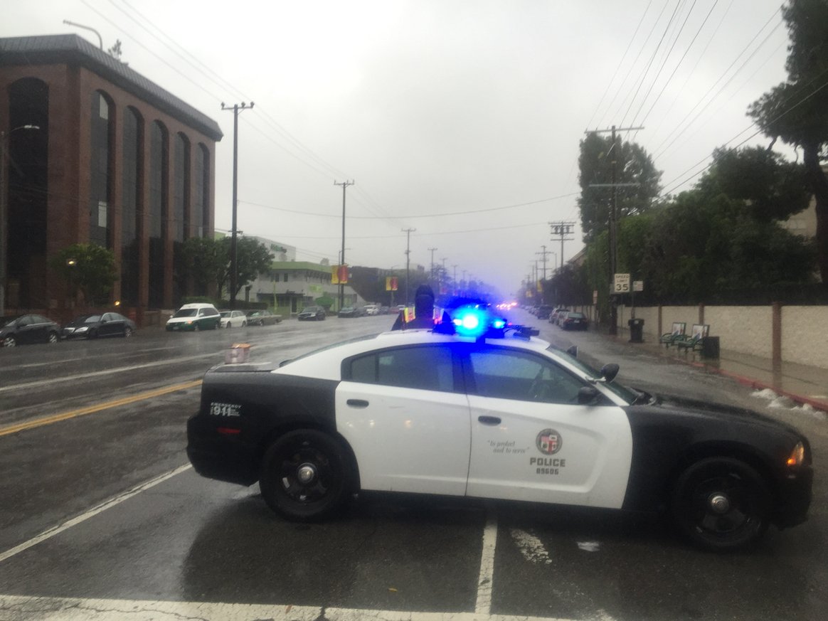 Wind driven rain pounds Sepulveda Blvd. where downed power lines caused injuries