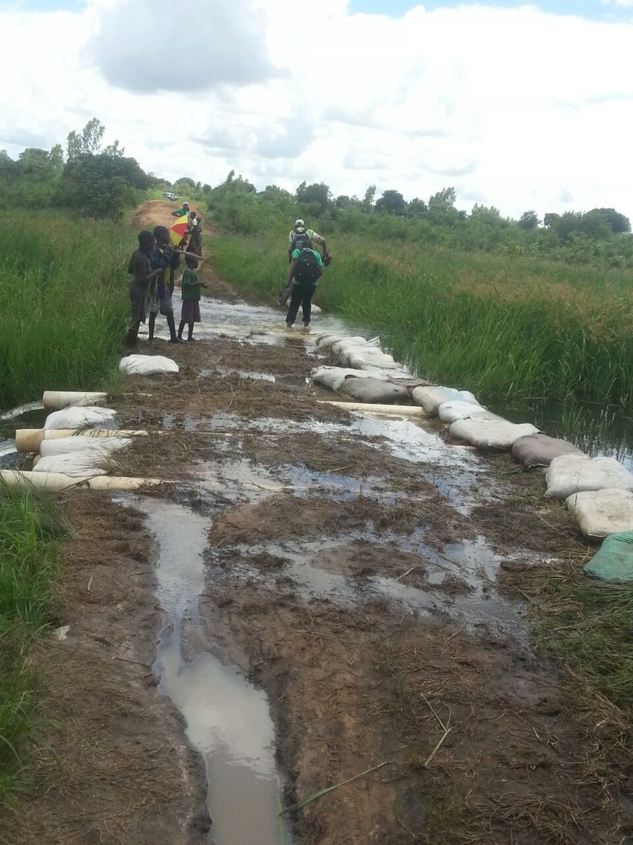 bicomalawi's tweet photo. &amp; being rainy season the roads are bad. Survey team proceeds to a cluster on foot leaving car behind. Day 1, #2017_Trachoma_Impact_Surveys https://t.co/A14QIYbqnS