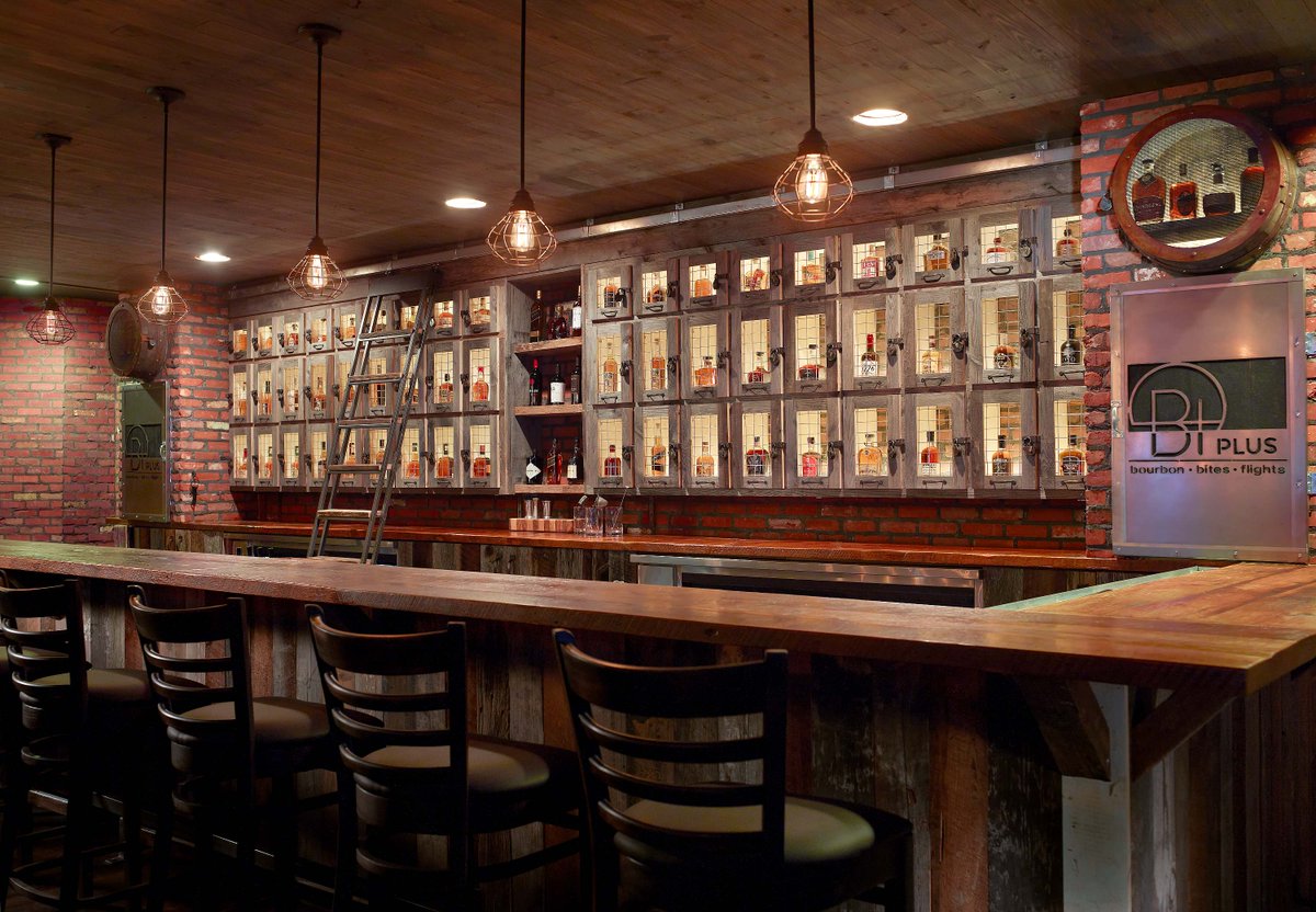 B+ Bourbon Bar now features a new brick faced and reclaimed wood walls, barn doors and site built bourbon lockers with wire mesh doors.