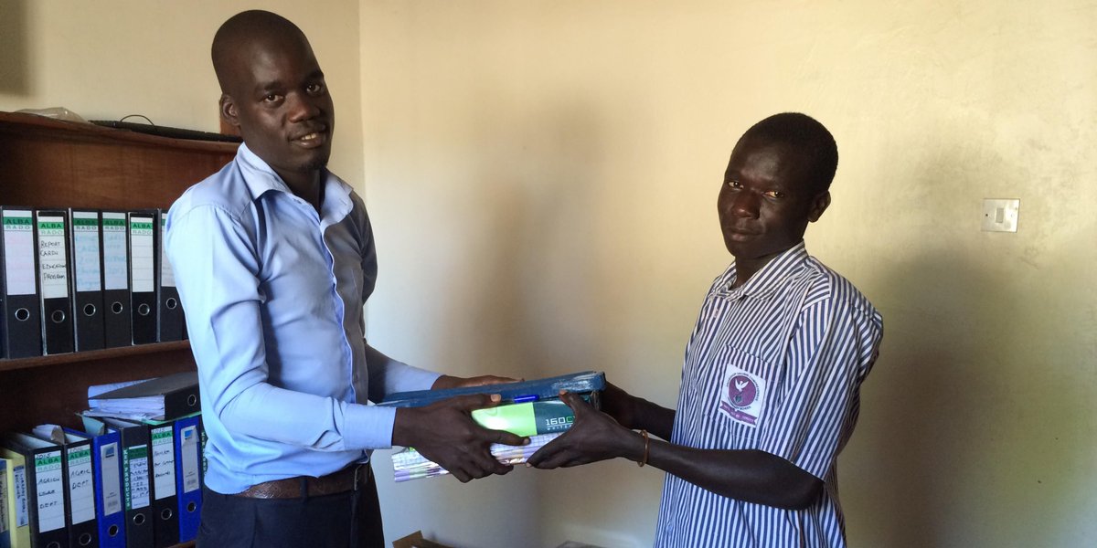 #Snapshot Lamex, our social worker, handing out scholastic supplies to one our beneficiaries that we are honoured to support in Uganda.