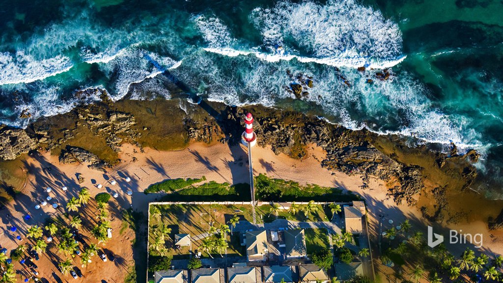 Itapuã Lighthouse stands between the crashing waves and Salvador, Bahia, Brazil. Bing.com