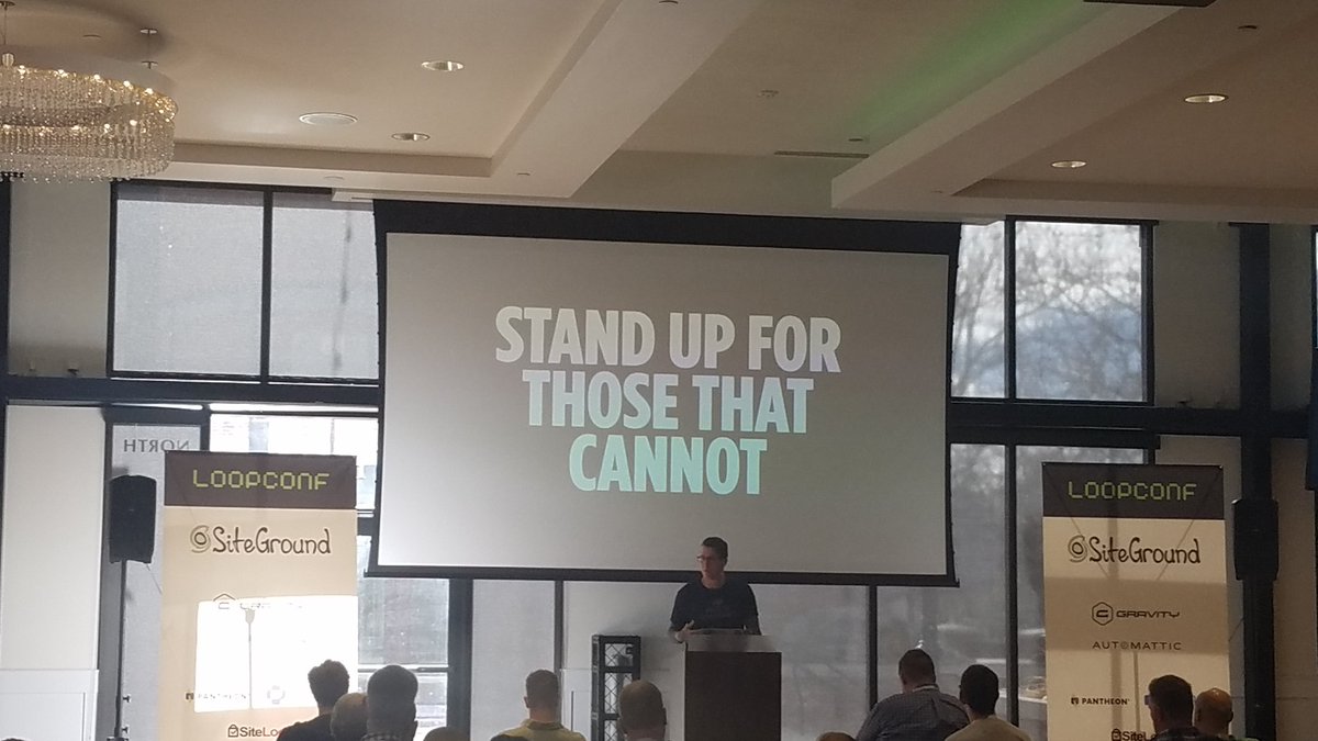Andrew Norcross in front of a screen that says Stand up for those that cannot