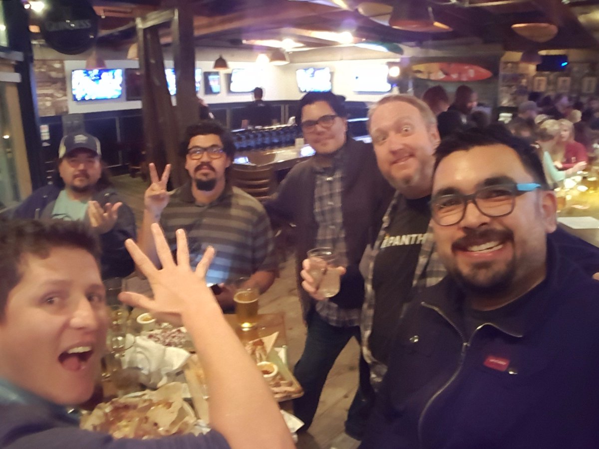 group of Drupal people drinking beer and waving at camera