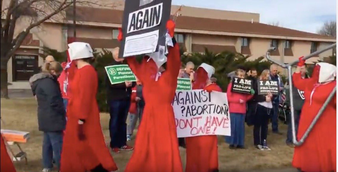 vaggiebitch's tweet photo. Handmaidens @PPProtest face to 😬with prolife zealots Lincoln NE #PP #resist #stopmatriarchy #BetsyRiot https://t.co/HXirXFhRrJ